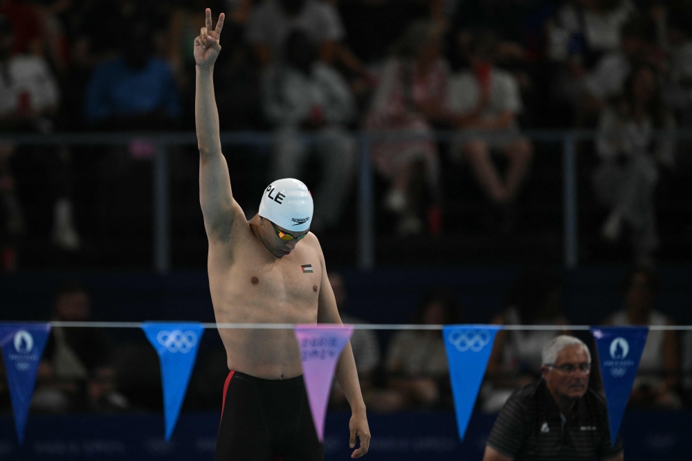 Palestine's Yazan Al Bawwab reacts before a heat of the men's 100m backstroke swimming event at the Paris La Defense Arena in Nanterre, on July 28, 2024. (Photo by Oli Scarff / AFP)