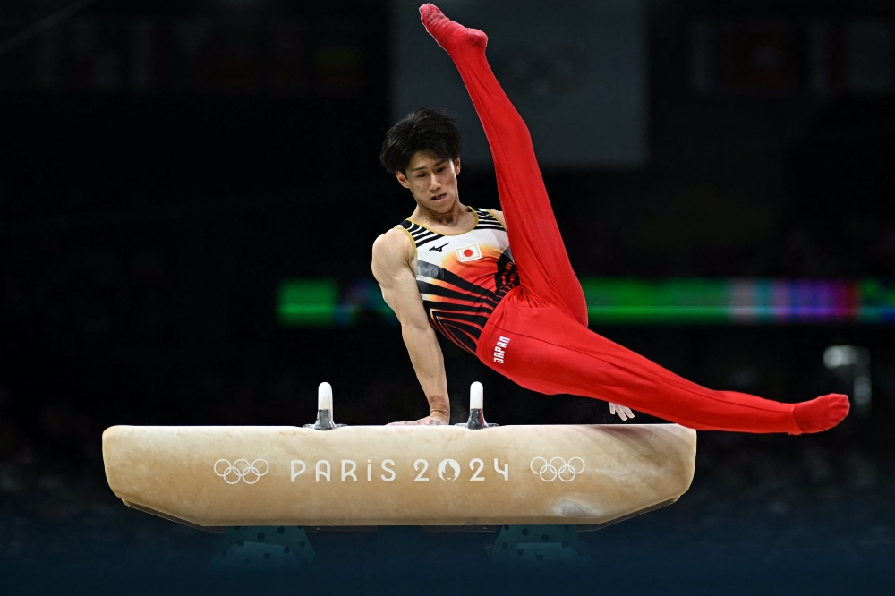 Japan's Daiki Hashimoto competes in the pommel horse event of the artistic gymnastics men's team final during the Paris 2024 Olympic Games at the Bercy Arena in Paris, on July 29, 2024. (Photo by Gabriel Bouys / AFP)