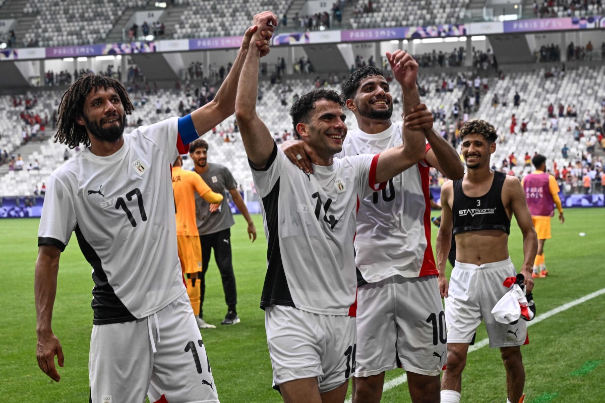 Egypt's midfielders #17 Mohamed Elneny, #14 Ahmed Zizo, #10 Ibrahim Adel and #03 Ahmed Atef celebrate their win at the end of the men's group C football match between Spain and Egypt during the Paris 2024 Olympic Games at the Bordeaux Stadium in Bordeaux on July 30, 2024. (Photo by Philippe Lopez / AFP)
