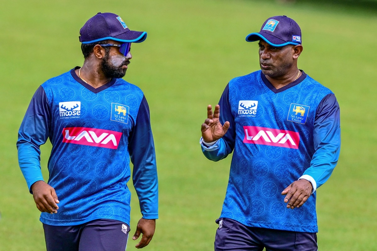 Sri Lanka's interim coach Sanath Jayasuriya (R) and captain Charith Asalanka speak during a practice session ahead of their first Twenty20 cricket match against India at the Pallekele International Cricket Stadium in Kandy on July 25, 2024. (Photo by Ishara S. KODIKARA / AFP)