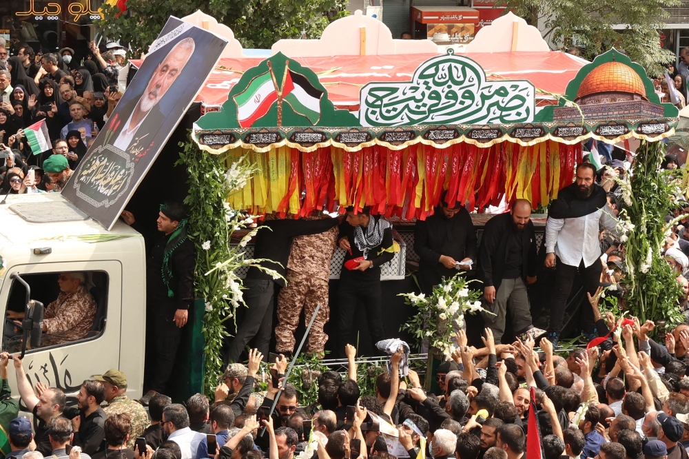 Iranians take part in a funeral ceremony for late Hamas leader Ismail Haniyeh, in Tehran, on August 1, 2024. (Photo by AFP)
