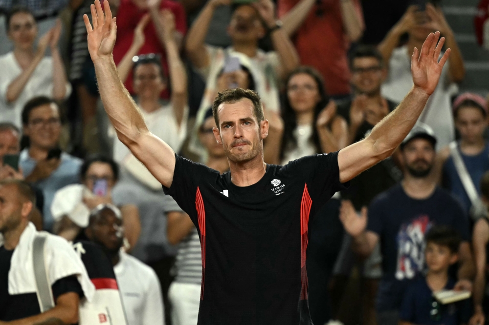 Britain's Andy Murray waves goodbye after playing with Britain's Daniel Evans against US' Taylor Fritz and US' Tommy Paul in their men's doubles quarter-final tennis match on Court Suzanne-Lenglen at the Roland-Garros Stadium during the Paris 2024 Olympic Games, in Paris on August 1, 2024. (Photo by Carl De Souza / AFP)