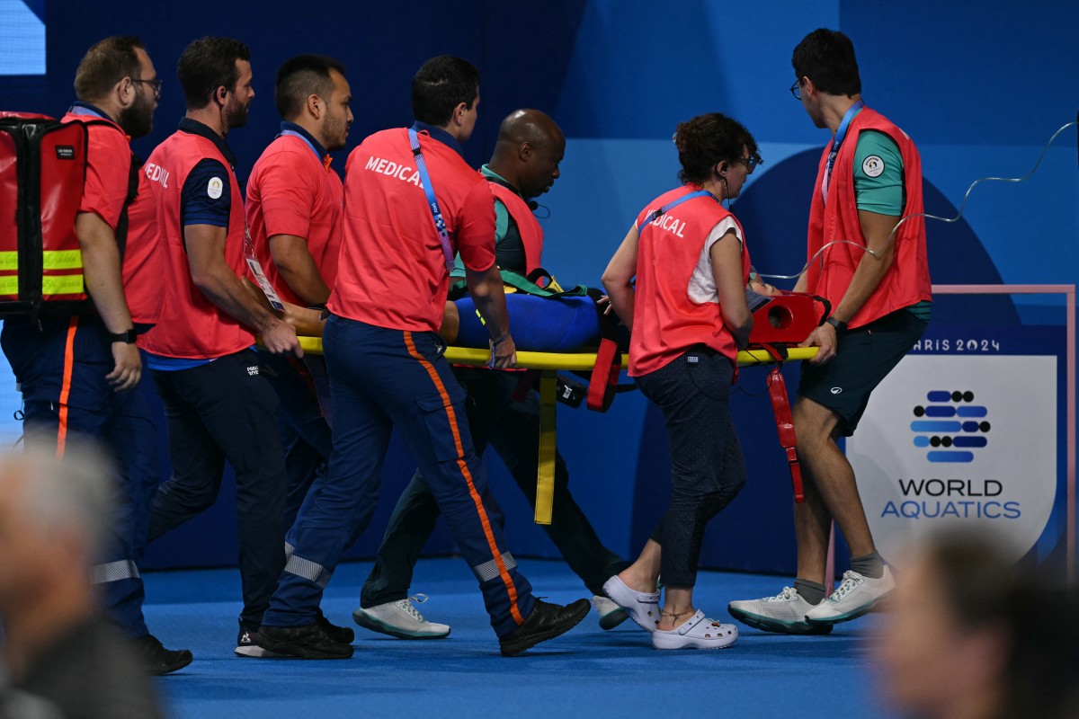 Medical staff carry Slovakia's Tamara Potocka on a stretcher after she collapsed following a heat of the women's 200m individual medley swimming event during the Paris 2024 Olympic Games at the Paris La Defense Arena in Nanterre, west of Paris, on August 2, 2024. Photo by Jonathan NACKSTRAND / AFP