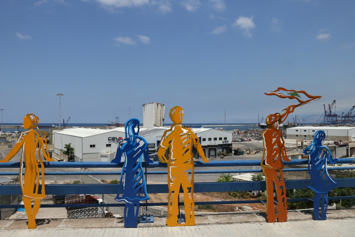 Sculpted figures representing people staring at the devastation are lined up along the road overlooking the port of Beirut on August 4, 2024, as Lebanon marks four years since a catastrophic explosion there that killed more than 220 people. Photo by Ibrahim AMRO / AFP.