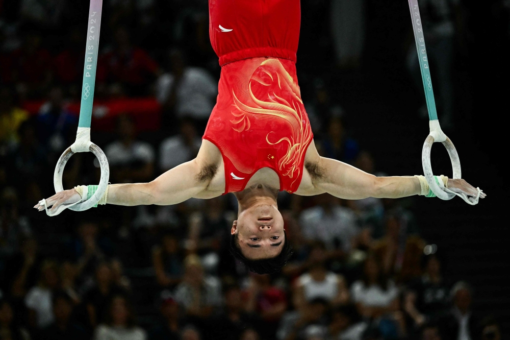 China's Liu Yang competes in the artistic gymnastics men's rings final during the Paris 2024 Olympic Games at the Bercy Arena in Paris, on August 4, 2024. (Photo by Loic VENANCE / AFP)
