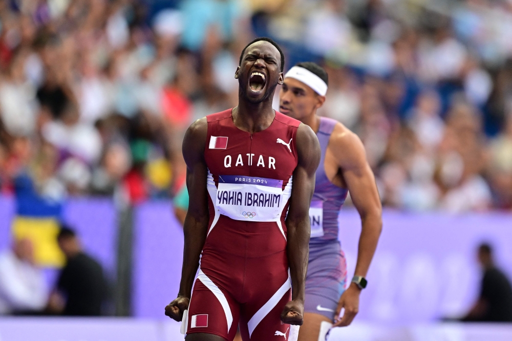 Qatar's Ammar Ismail Yahia Ibrahim reacts after competing in the men's 400m heat of the athletics event at the Paris 2024 Olympic Games at Stade de France in Saint-Denis, north of Paris, on August 4, 2024. (Photo by Martin Bernetti / AFP)