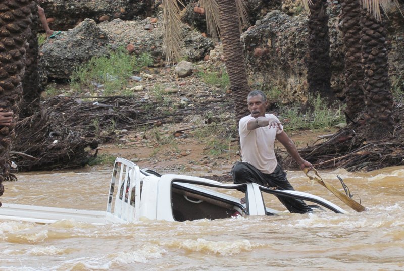 File photo: A man gestures as he tries to save a vehicle swept away by flood waters in Yemen's island of Socotra November 2, 2015.Reuters
