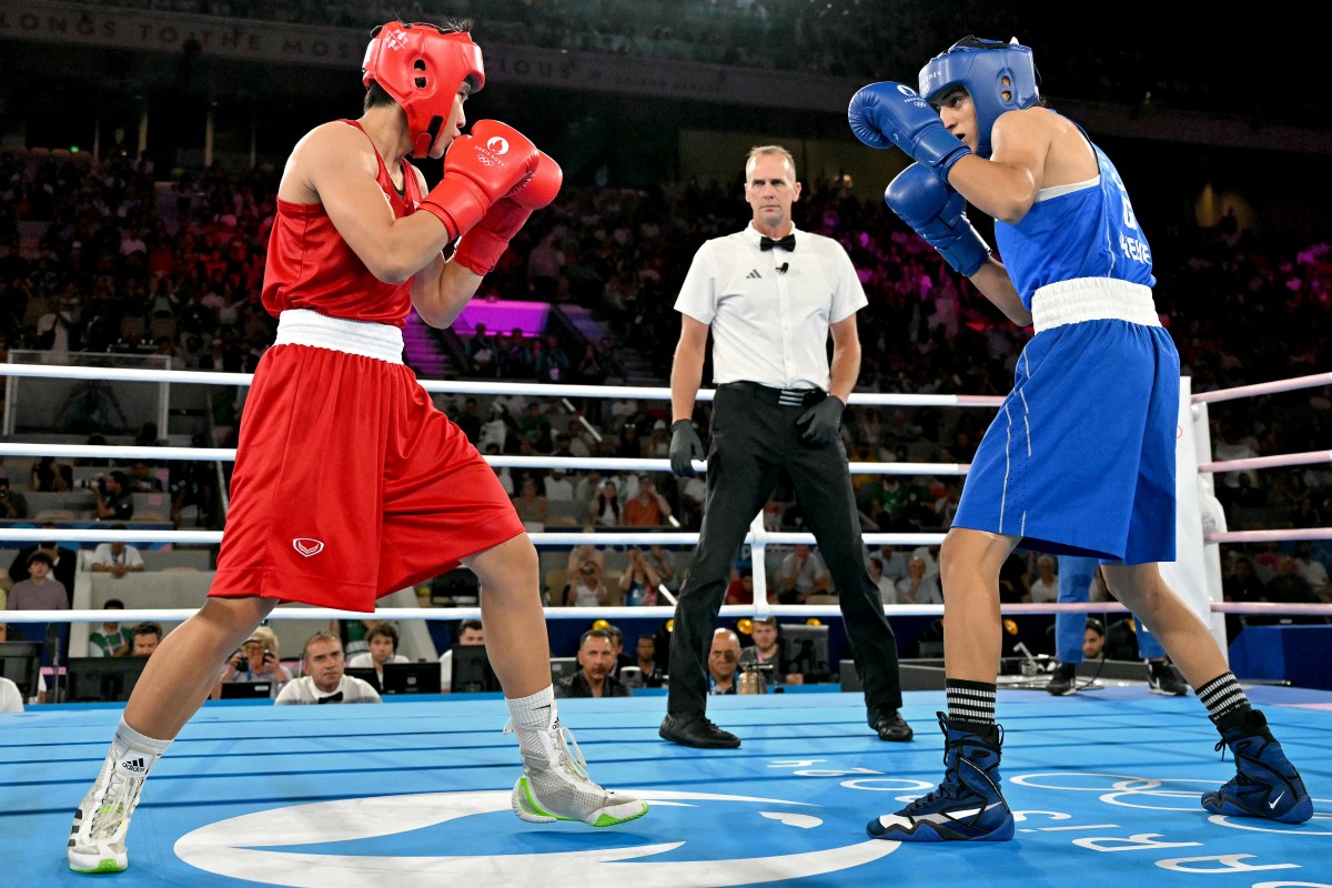 Thailand's Janjaem Suwannapheng and Algeria's Imane Khelif (Blue) compete in the women's 66kg semi-final boxing match during the Paris 2024 Olympic Games at the Roland-Garros Stadium, in Paris on August 6, 2024. Photo by MOHD RASFAN / AFP.