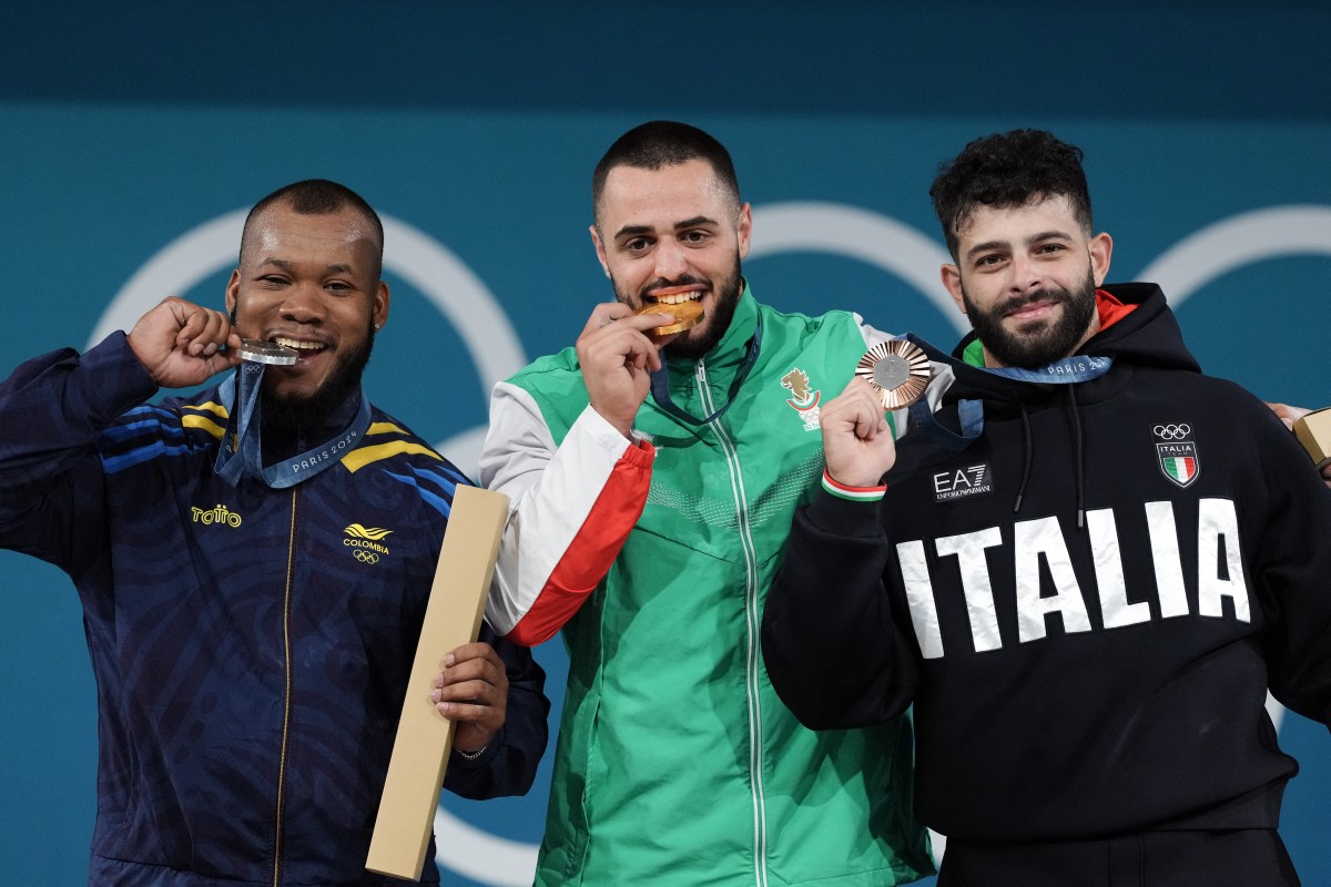 Gold medallist Bulgaria's Karlos May Nasar (C), silver medallist Colombia's Yeison Lopez (L) and bronze medallist Italy's Antonino Pizzolato (R) pose on the podium after the men's -89kg weightlifting event during the Paris 2024 Olympic Games at the South Paris Arena in Paris, on August 9, 2024. Photo by Dimitar DILKOFF / AFP.