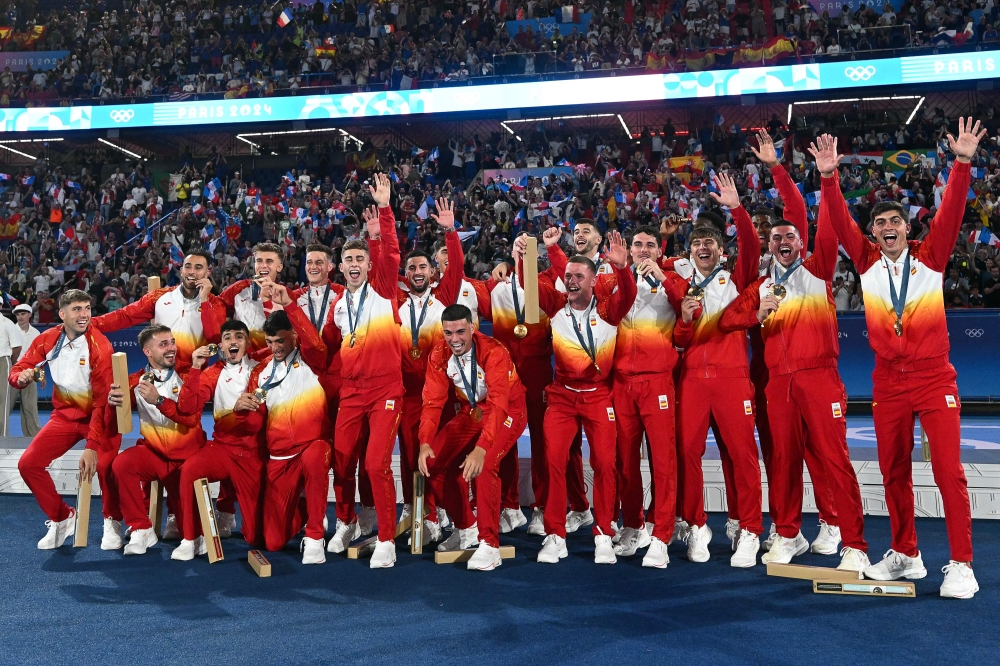 Spain's gold medallists celebrate on the podium after the men's final football match between France and Spain during the Paris 2024 Olympic Games at the Parc des Princes in Paris on August 9, 2024. (Photo by Patricia De Melo Moreira/ AFP)