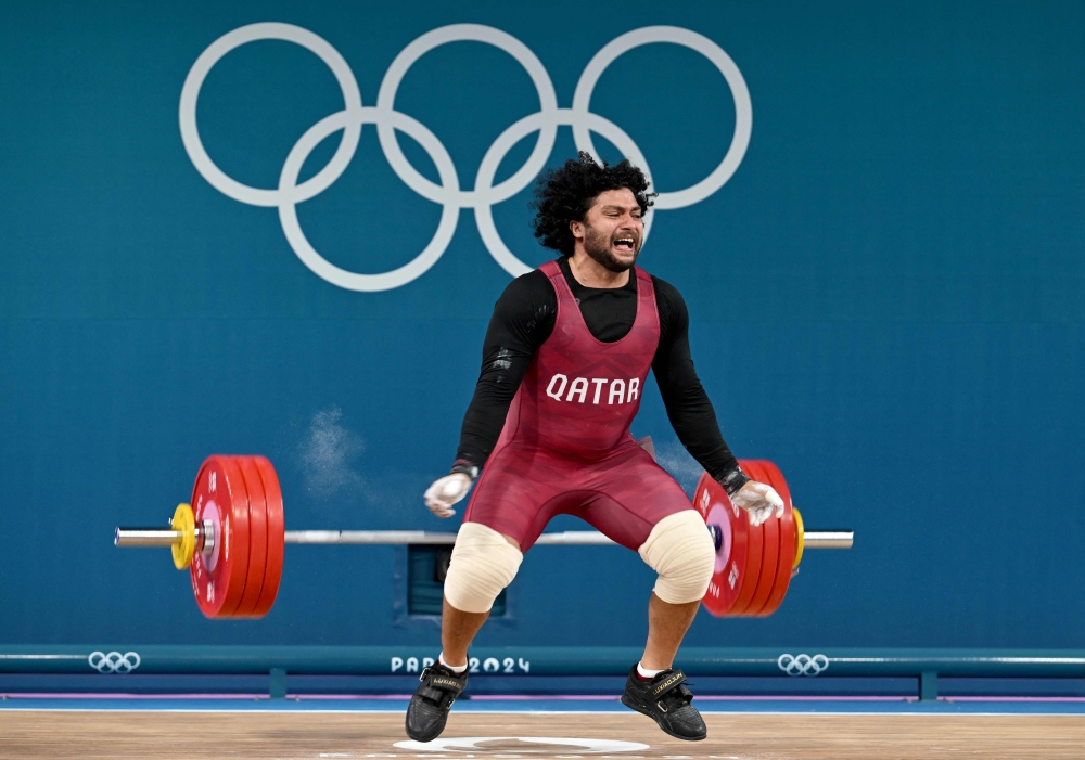 Qatar's Faris Ibrahim E Elbakh fails in the men's -102kg weightlifting event during the Paris 2024 Olympic Games at the South Paris Arena in Paris, on August 10, 2024. (Photo by ARUN SANKAR / AFP)
