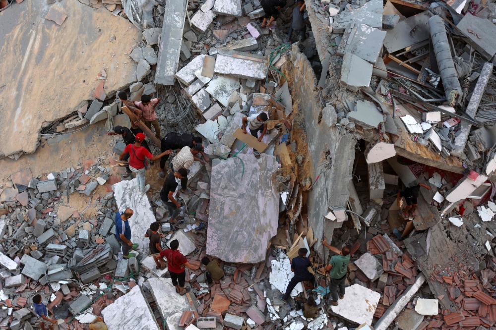 People inspect the damage in Gaza City's Sheikh Radwan neighbourhood in Gaza City following Israeli bombardment on August 11, 2024. (Photo by Omar Al-Qattaa / AFP)

