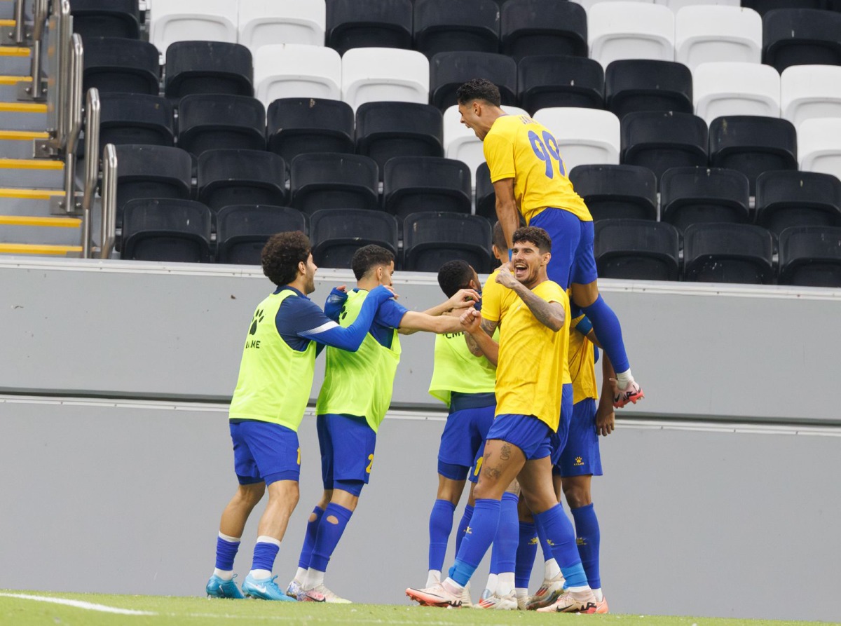 Al Gharafa players celebrate after Ferjani Sassi scored a goal against Shabab Al Ahli.