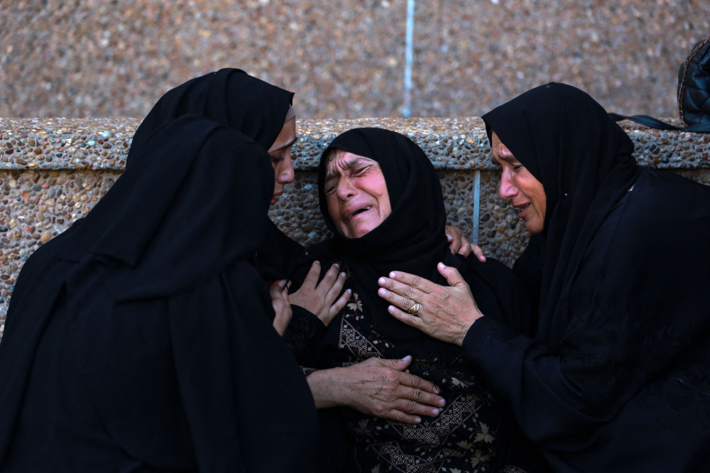 A Palestinian woman mourns a family member killed in Israeli bombardment, at the Nasser hospital in Khan Yunis in the southern Gaza Strip on August 14, 2024. (Photo by Bashar Taleb / AFP)