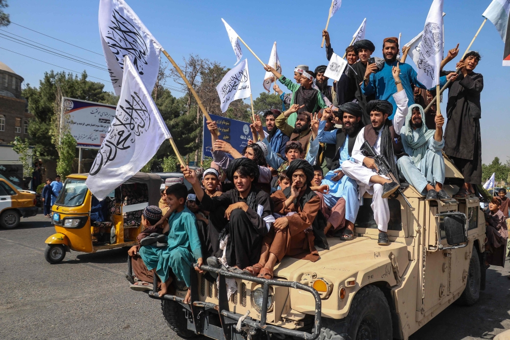 A convoy of Taliban security personnel seen moving along the streets as they celebrate the third anniversary of Taliban takeover of Afghanistan, in Herat on August 14, 2024. (Photo by Mohsen KarimI / AFP)
