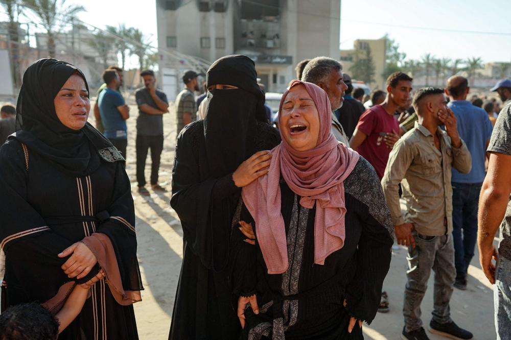 A Palestinian woman mourns a family member killed in Israeli bombardment, at the Nasser hospital in Khan Yunis in the southern Gaza Strip on August 14, 2024. (Photo by Bashar Taleb / AFP)