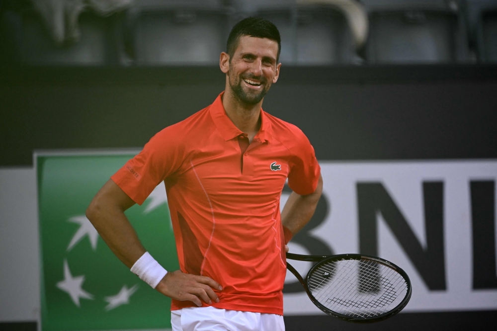 Serbia's Novak Djokovic smiles during his match against France's Corentin Moutet during the Men's ATP Rome Open tennis tournament at Foro Italico in Rome on May 10, 2024. (Photo by Filippo Monteforte / AFP)

