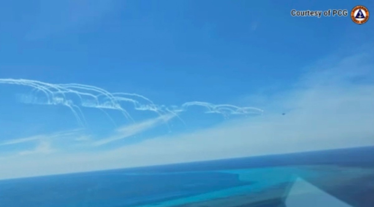 This screengrab from the Philippine Coast Guard (PCG) handout video taken on August 19, 2024, and received on August 24, 2024, shows a Chinese air force fighter jet deploying flares near a Philippine Bureau of Fisheries and Aquatic Resources (BFAR) plane that was conducting a maritime domain awareness flight near China-controlled Scarborough Shoal in the South China Sea. Photo by Handout / Philippine Coast Guard (PCG) / AFP.