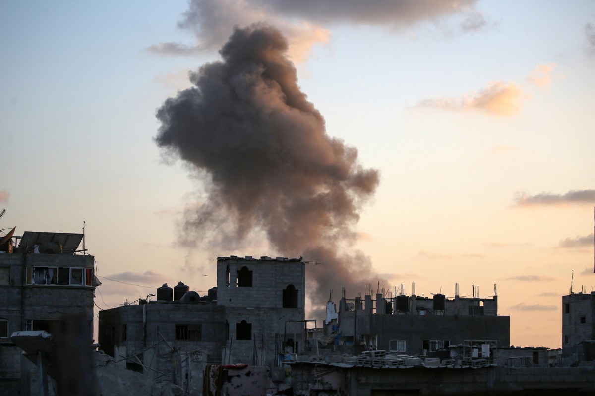 Smoke rises as Israeli troops target a building in the Nuseirat refugee camp in the central Gaza Strip on August 22, 2024. Photo by Eyad BABA / AFP.