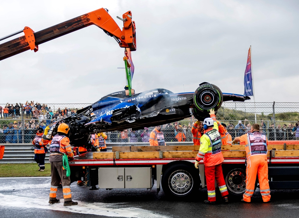 The car of Williams' US driver Logan Sargeant is lifted after a crash during the third practice session at The Circuit Zandvoort, western Netherlands, on August 24, 2024, ahead of the Formula One Dutch Grand Prix. (Photo by Remko de Waal / ANP / AFP) / Netherlands OUT