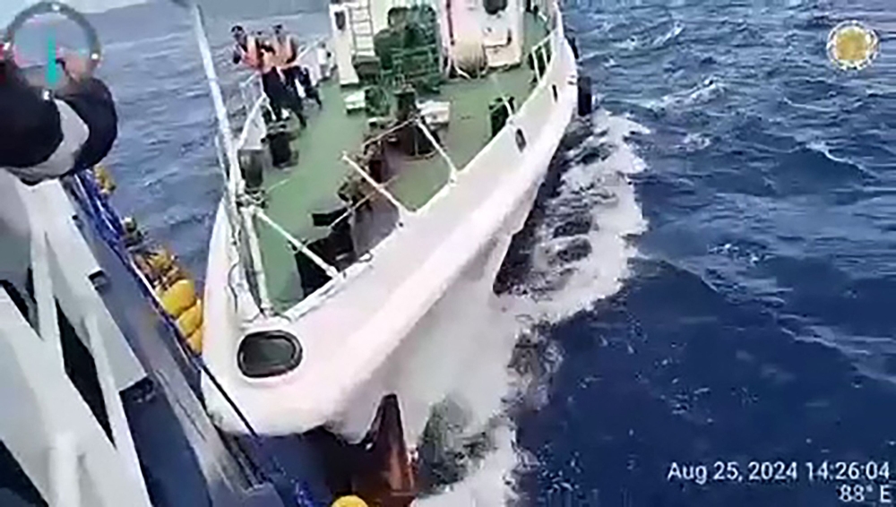 This frame grab from handout video footage taken and released on August 25, 2024 by the Philippine Coast Guard (PCG) shows a Chinese coast Guard ship (R) in a collision with the Philippine Bureau of Fisheries and Aquatic Resources (BFAR) vessel BRP Datu Sanday, near Sabina Shoal in disputed waters of the South China Sea. Photo by Handout / Philippine Coast Guard (PCG) / AFP