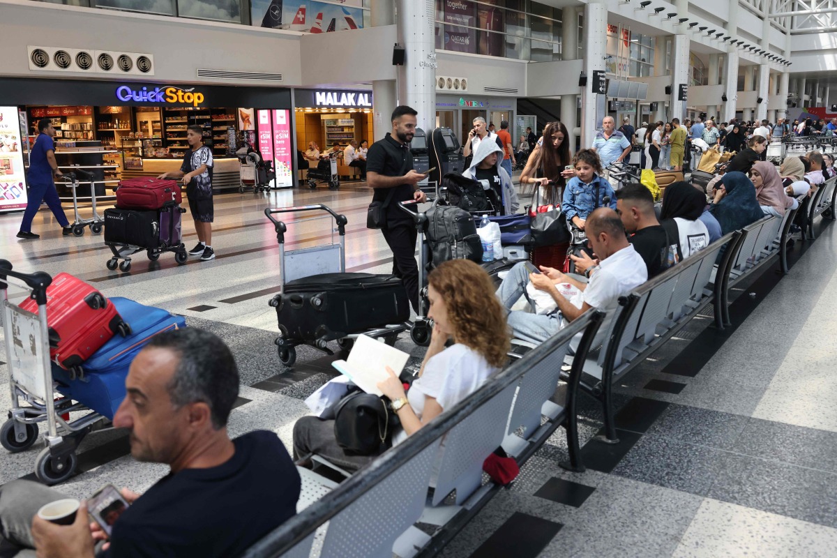 Passengers wait for their flights at the Beirut International Airport in Beirut yesterday. (AFP)