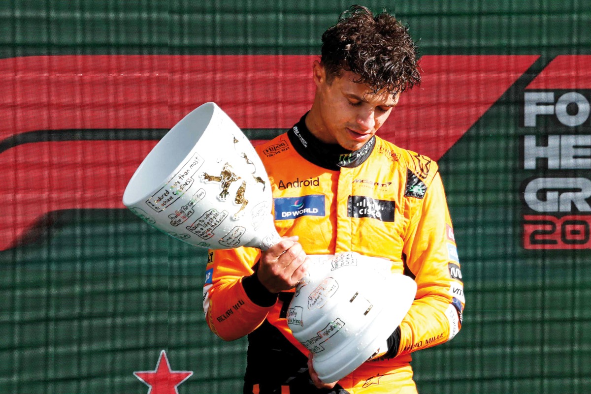 Winner McLaren’s British driver Lando Norris celebrates during the podium ceremony.