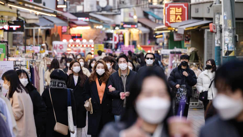 File photo of people walking the streets of Seoul. 