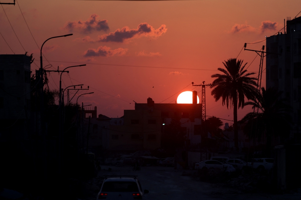 The sun sets over Tulkarem during an Israeli military raid on the northern city and its refugee camp in the occupied West Bank on September 2, 2024. (Photo by JAAFAR ASHTIYEH / AFP)
