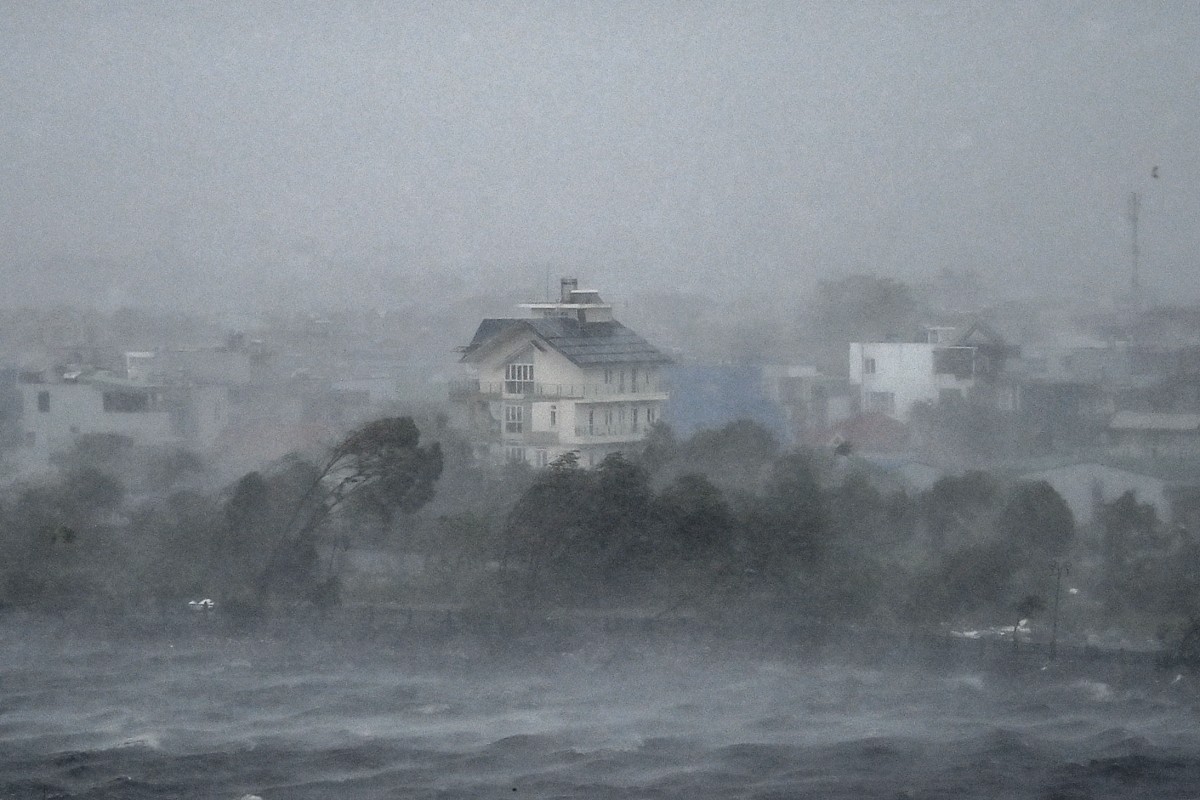 Water is whipped up by high winds onto the shore of Phuong Luu lake as Super Typhoon Yagi hits Hai Phong on September 7, 2024. Photo by NHAC NGUYEN / AFP.