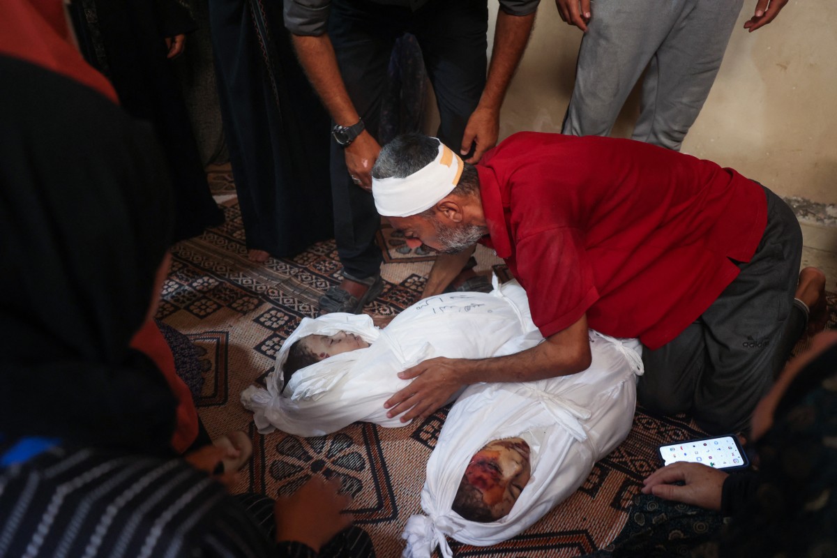 Graphic content / Relatives and friends mourn by the bodies of Mira Thaer Eid, 3, and Misk Hasan Eid, 5, during their funeral at the Nuseirat camp for displaced Palestinians in the central Gaza Strip on September 8, 2024, after they succumbed to wounds sustained a day earlier during Israeli bombardment of their family home east of the camp. Photo by Eyad BABA / AFP.