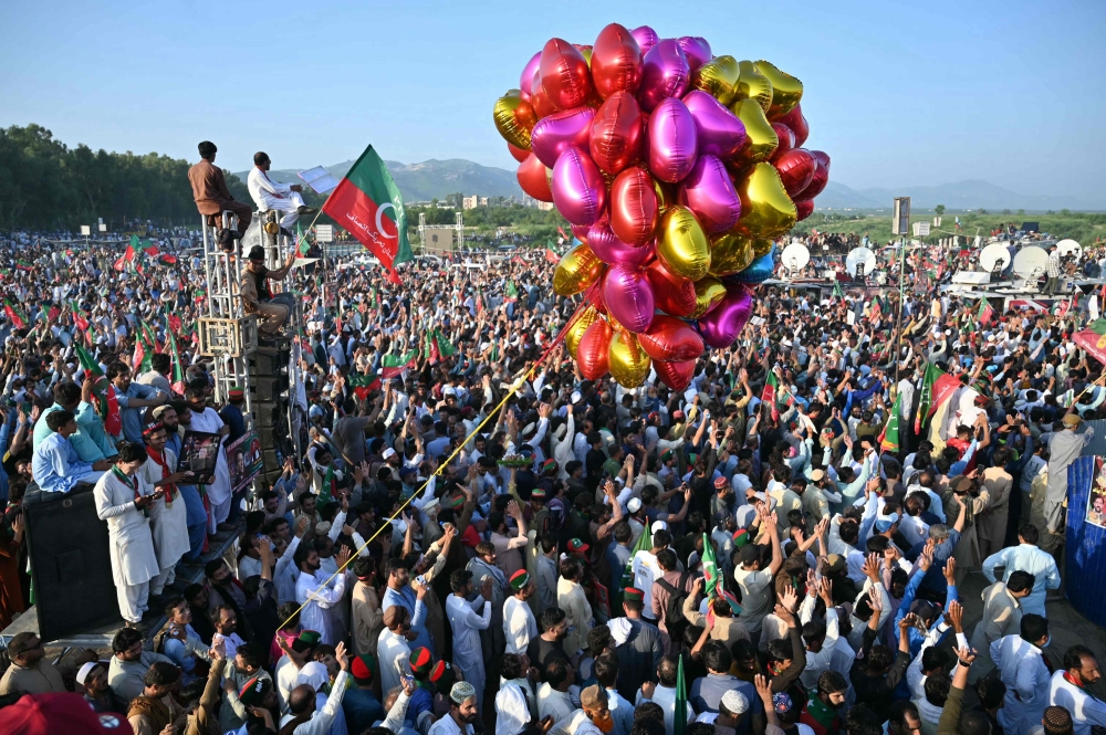 Activists of Pakistan Tehreek-e-Insaf (PTI) party of former country's prime minister Imran Khan, take part in a public rally on the outskirts of Islamabad on September 8, 2024. (Photo by Farooq Naeem / AFP)