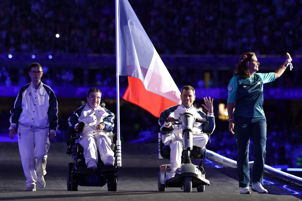 France's Aurelie Aubert (2nd L) and France's Tanguy De La Forest (2nd R) parade on stage during the Paris 2024 Paralympic Games Closing Ceremony at the Stade de France, in Saint-Denis, in the outskirts of Paris, on September 8, 2024. (Photo by Thibaud Moritz / AFP)