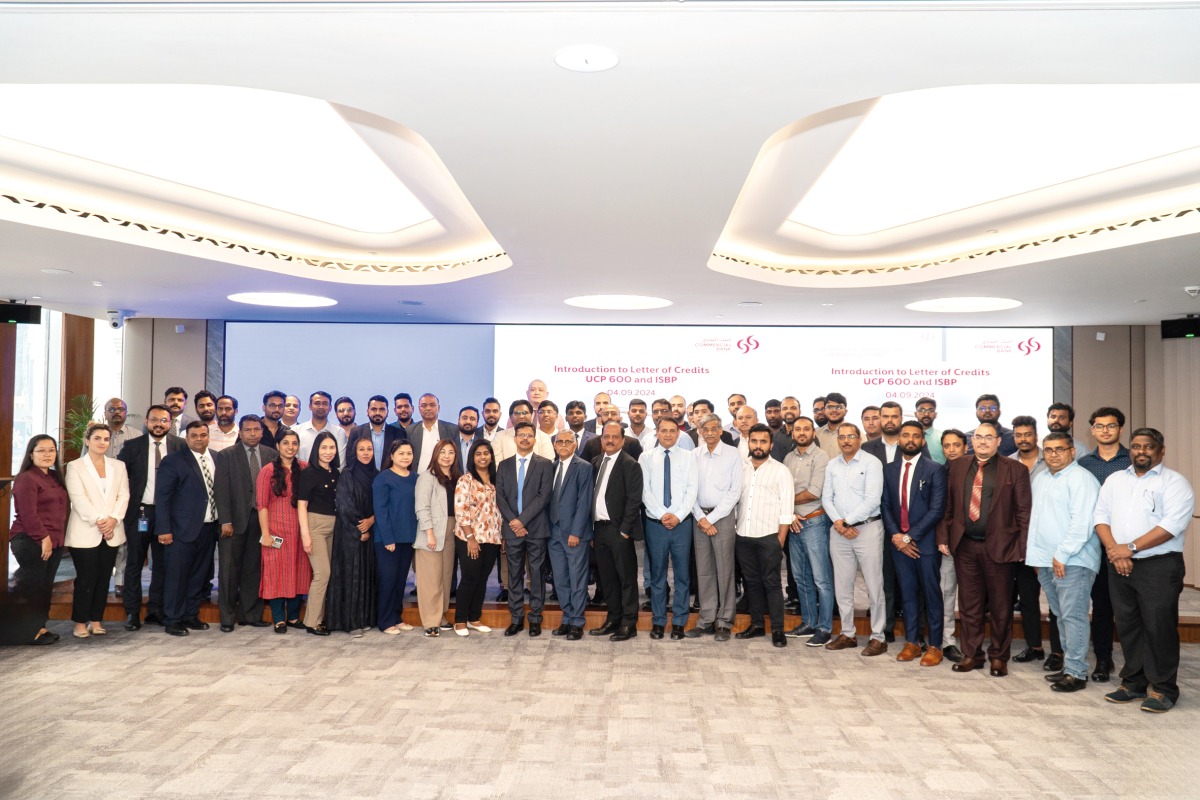 Commercial Bank officials posing for a group photo along with attendees during the trade workshop.