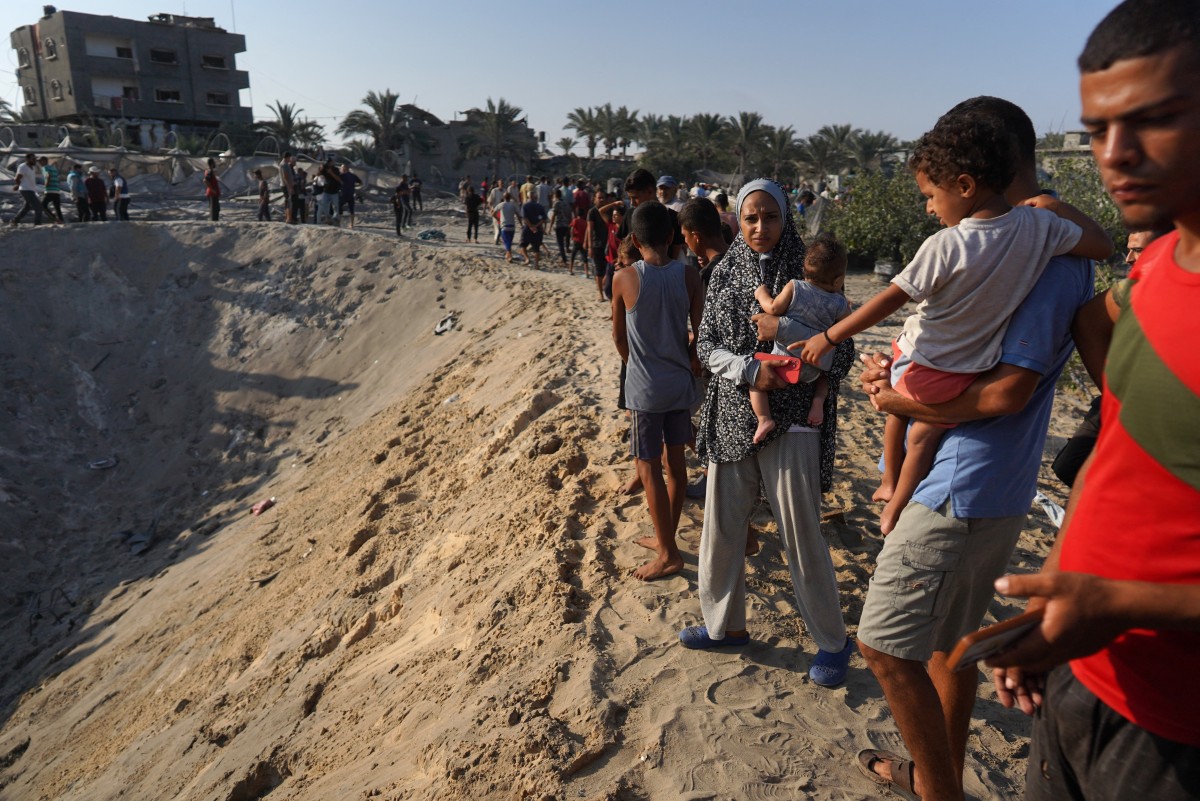 Palestinians inspect the damage at the site of Israeli strikes on a makeshift displacement camp in Mawasi Khan Yunis in the Gaza Strip on September 10, 2024. Photo by Bashar TALEB / AFP.