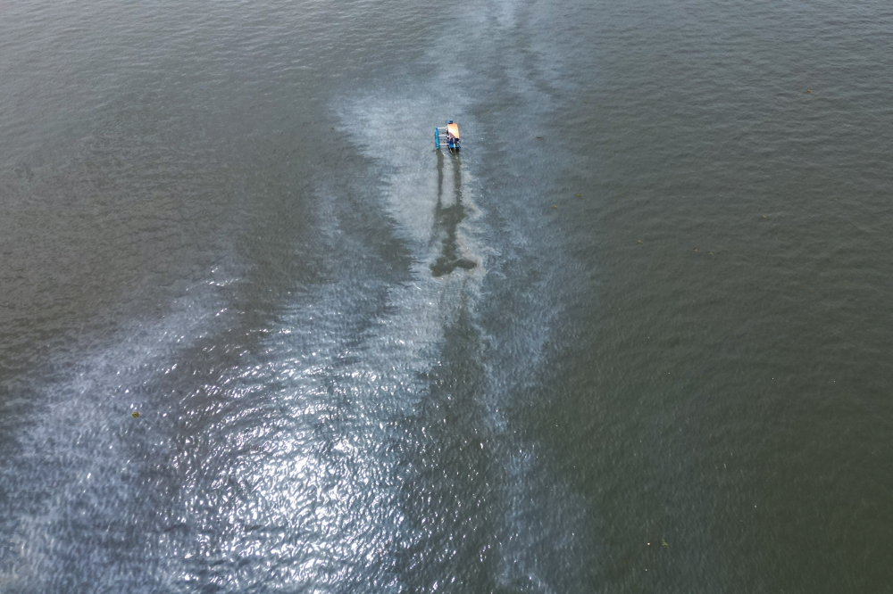 This aerial photo shows an oil slick in Manila Bay, about two kilometres off the coast of Malolos municipality, Bulacan province on July 29, 2024. Photo by JAM STA ROSA / AFP
