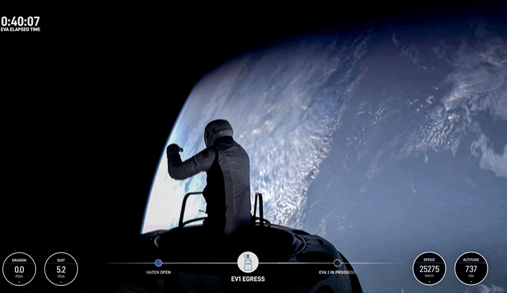 This still image taken from a SpaceX and Polaris broadcast on September 12, 2024, shows US fintech billionaire Jared Isaacman (EV1) peeking out to space from a hatch structure called 