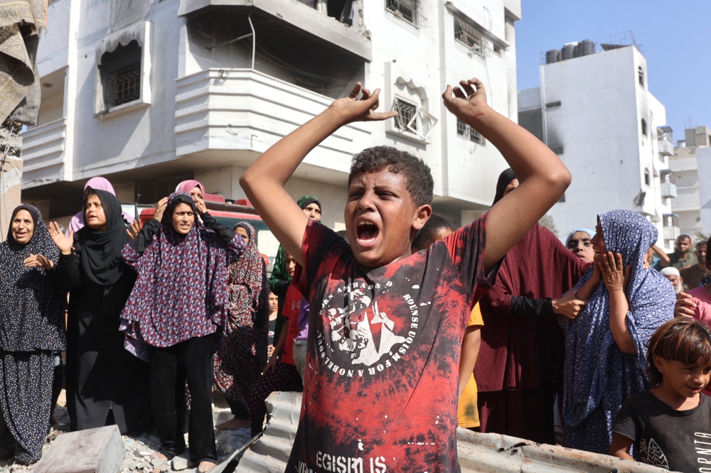 A Palestinian boy reacts at the site of an Israeli strike in the Shejaiya suburb east of Gaza City on September 12, 2024. (Photo by Omar Al-Qattaa/ AFP)

