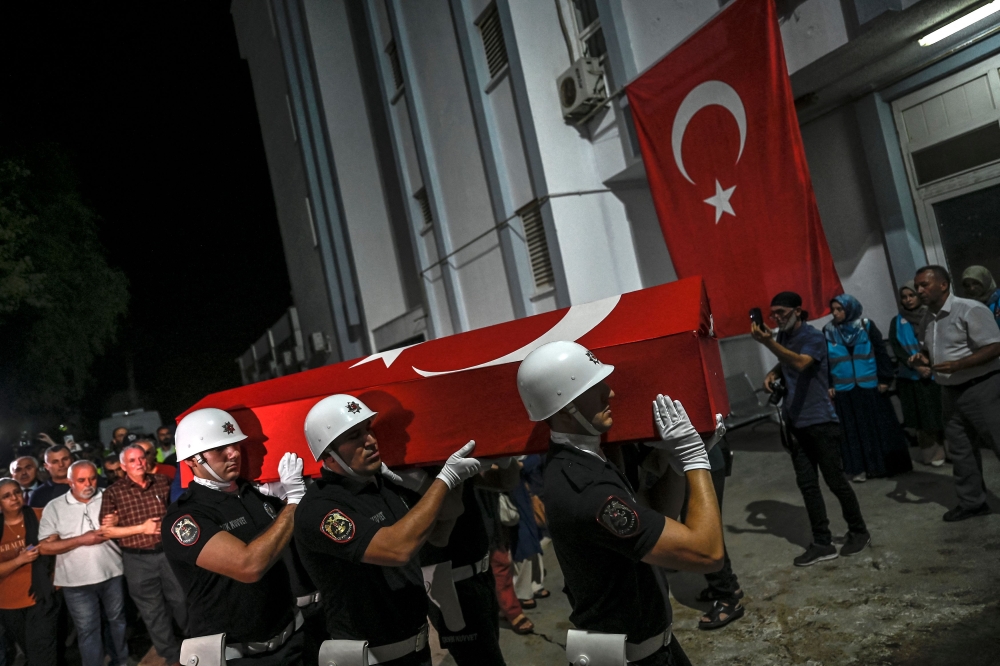 Coffin of US-Turkish activist Aysenur Ezgi Eygi is carried by Turkish honor guard police officers to a morgue at the Didim district in Aydin on September 13, 2024. (Photo by Ozan Kose / AFP)