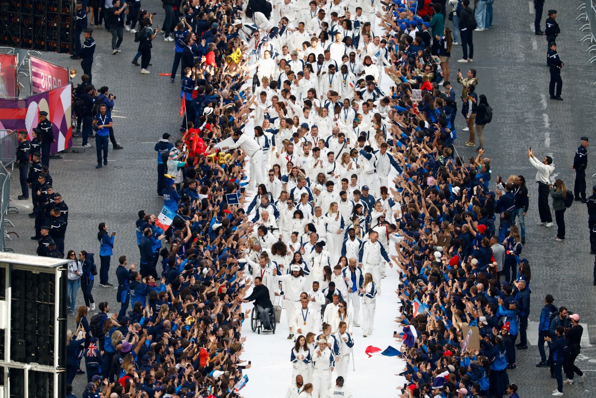 French athletes who participated in the 2024 Olympics and Paralympics walk on a catwalk at the Avenue des Champs-Elysees, in Paris, France September 14, 2024. Photo by Gonzalo Fuentes / POOL / AFP.