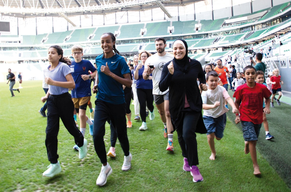 Olympic marathon champion Sifan Hassan (third left) participates in a run after the launch of the Creating Pathways Program at the Education City Stadium yesterday. 