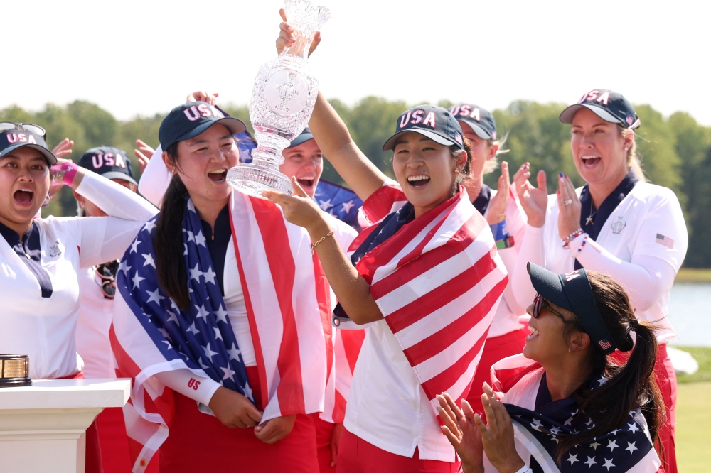 Allisen Corpuz and Rose Zhang of Team United States react after Team United States wins the Solheim Cup during the Sunday Singles matches during the final round of the Solheim Cup 2024 at Robert Trent Jones Golf Club on September 15, 2024 in Gainesville, Virginia. (Photo by Gregory Shamus/Getty Images via AFP)