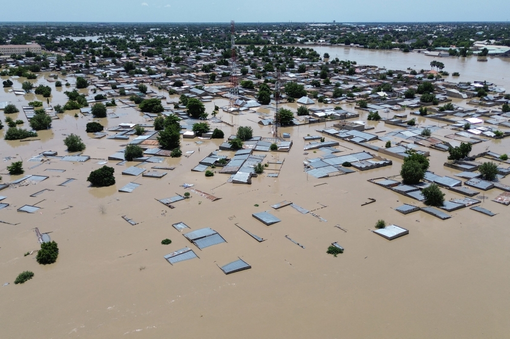 This aerial view shows houses submerged under water in Maiduguri on September 10, 2024. (Photo by Audu Marte / AFP)