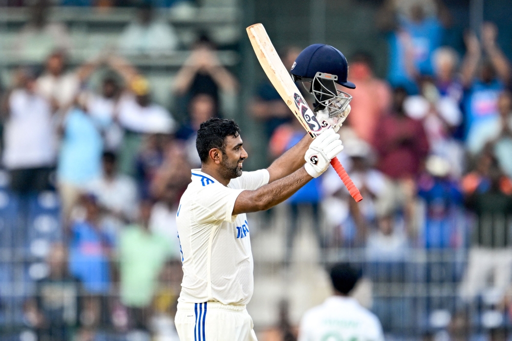 India's Ravichandran Ashwin celebrates after scoring a century (100 runs) during the first day of the first Test cricket match on September 19, 2024. (Photo by R.Satish Babu / AFP)