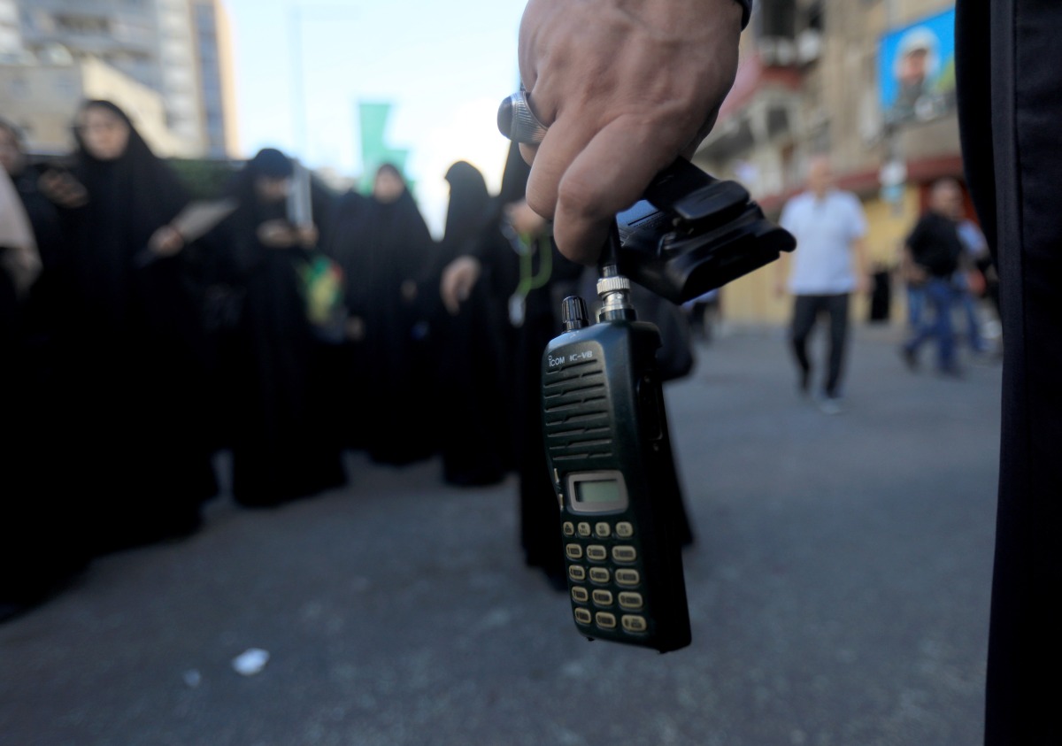 Hezbollah member holds a wireless communication device with its battery removed after a wireless communication device exploded during a funeral, in Beirut, Lebanon, on Sept. 18, 2024. (Xinhua/Bilal Jawich)
