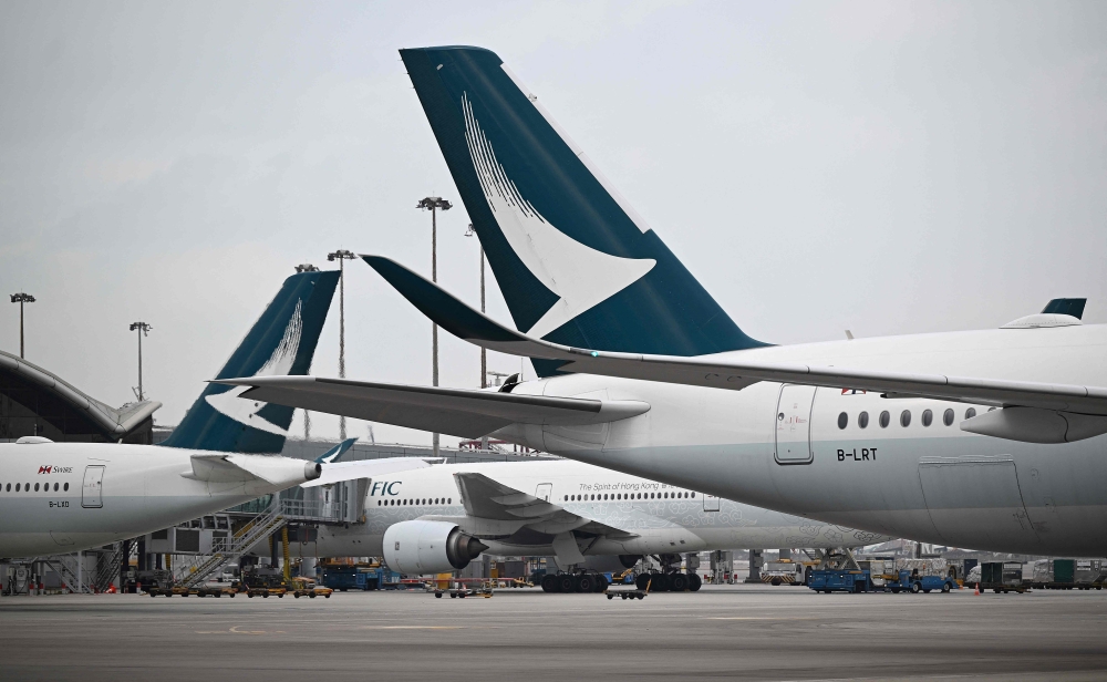 This photo taken on December 13, 2023 shows Cathay Pacific aircraft parked at Hong Kong international airport. Photo by Peter PARKS / AFP