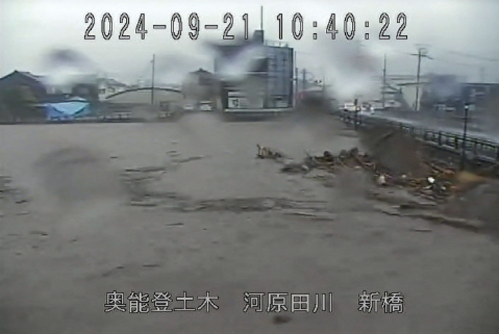 This handout image taken from a CCTV camera from the Ishikawa Prefectural River Information System and received via Jiji Press on September 21, 2024 shows the Kawarada River near its crest due to heavy rains in the city of Wajima, Ishikawa Prefecture. (Photo by Handout / various sources / AFP) 