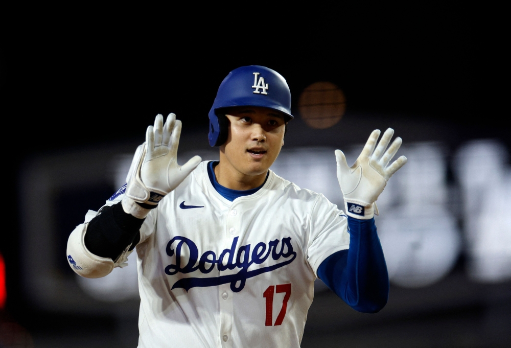 Designated hitter Shohei Ohtani #17 of the Los Angeles Dodgers celebrates as he runs the bases after hitting his 52nd career home run against starting pitcher Kyle Freeland #21 of the Colorado Rockies during the fifth inning at Dodger Stadium on September 20, 2024 in Los Angeles, California. Kevork Djansezian/Getty Images/AFP