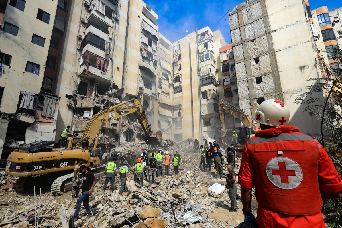 Rescuers sift through the rubble at the scene of an Israeli airstrike that targeted Beirut's southern suburbs a day earlier, as search and rescue operations continue on September 21, 2024. Photo by AFP.