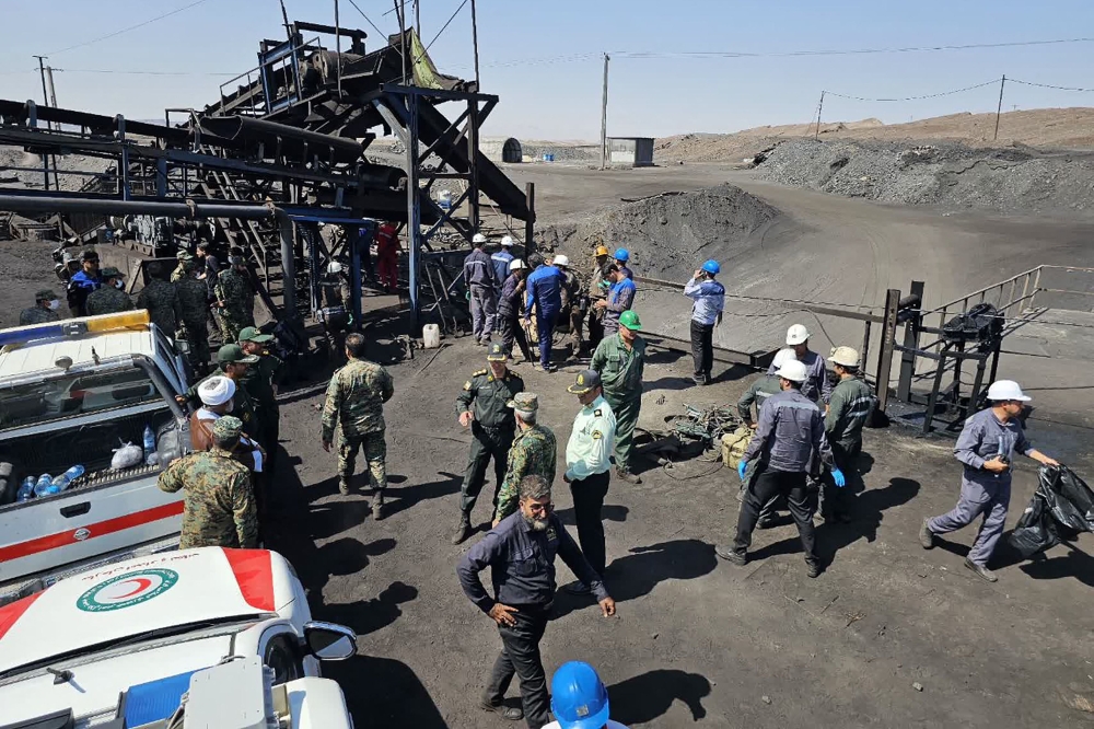 A handout picture provided by the Iranian Red Crescent (RCS) shows security forces gathered at the scene of a blast at a coal mine in Tabas on September 22, 2024. (Photo by Iranian Red Crescent / AFP) 